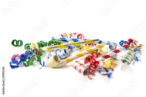 A group of party items, noisemakers and ribbons New Years theme