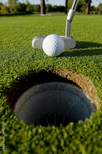 A short put in the game of golf with a ball and a putter