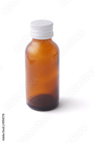 Empty medicine bottle with white cap on white background