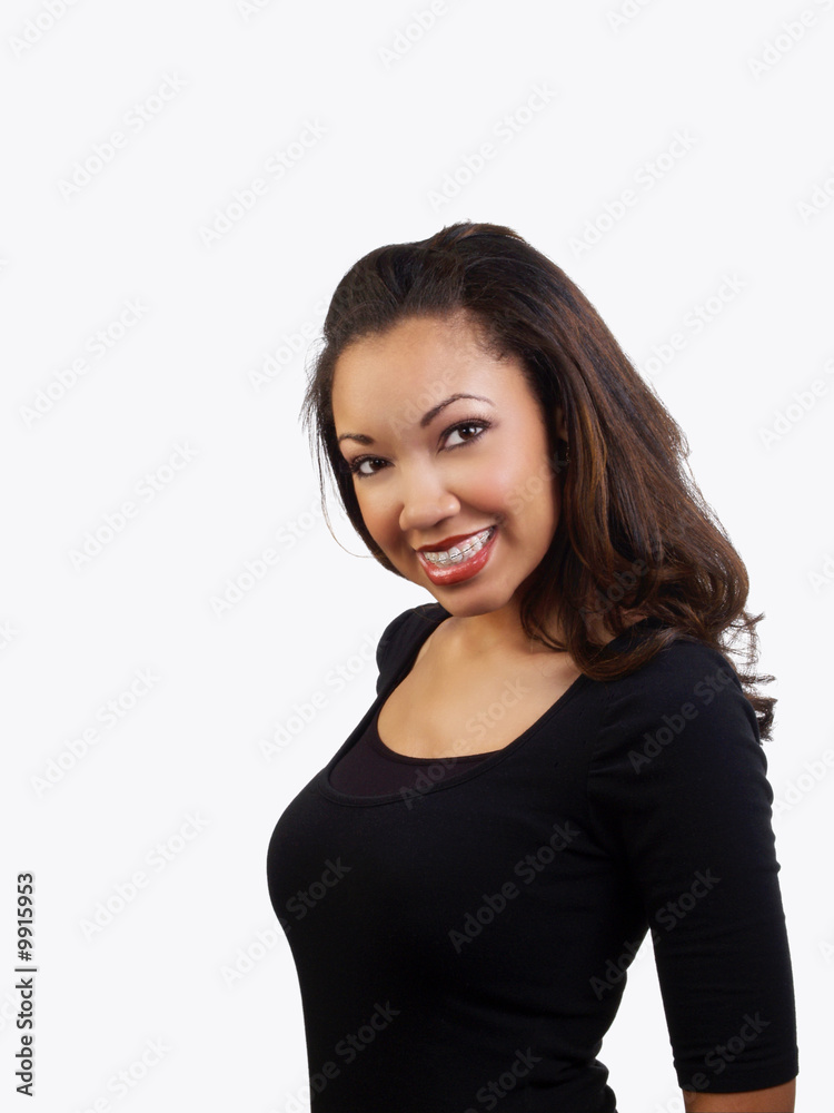 Smiling portrait of young black woman with braces on teeth Smiling portrait of young black woman with braces on teeth