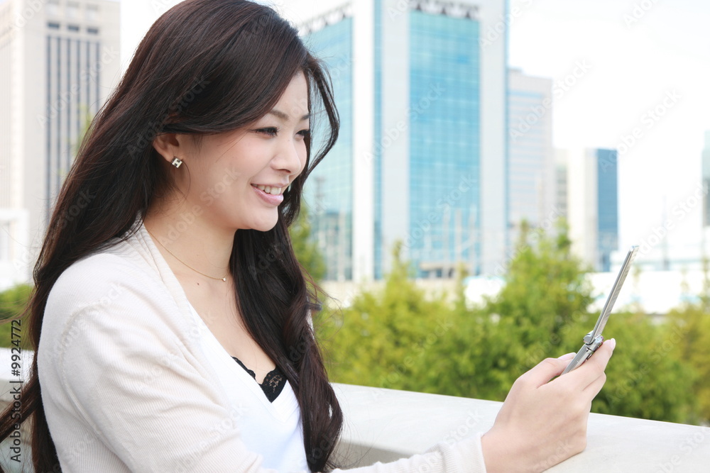 Fototapeta premium young woman with mobile phone