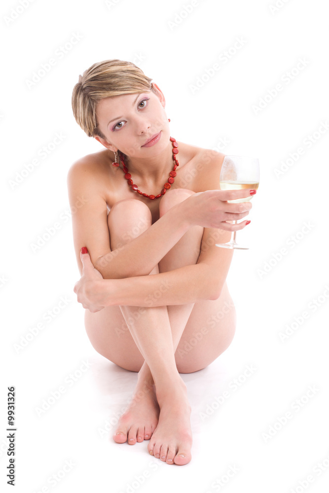 Obraz premium Portrait of naked girl with wineglass sitting over white
