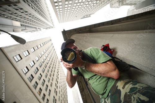 Photographer in New York City. Wide angle view from below. photo