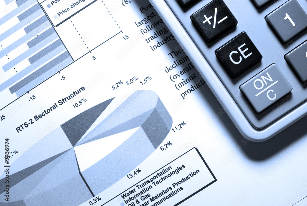 Calculator and printed stock data with diagrams. Calculator and printed stock data with diagrams.
