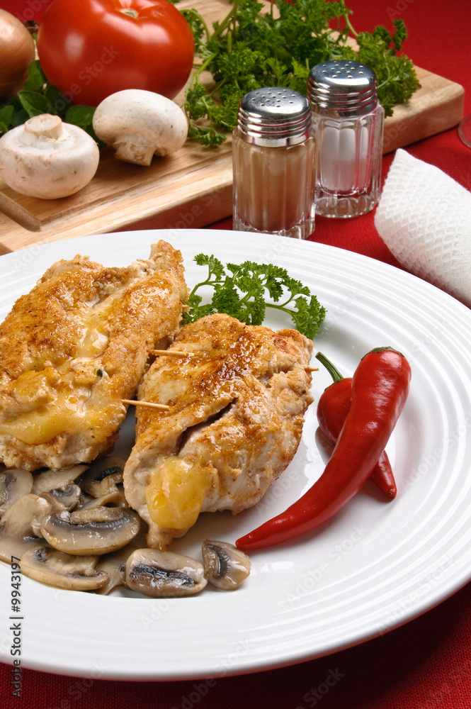 Stuffed fried chicken fillets with cheese, ham, and vegetables Stuffed fried chicken fillets with cheese, ham, and vegetables