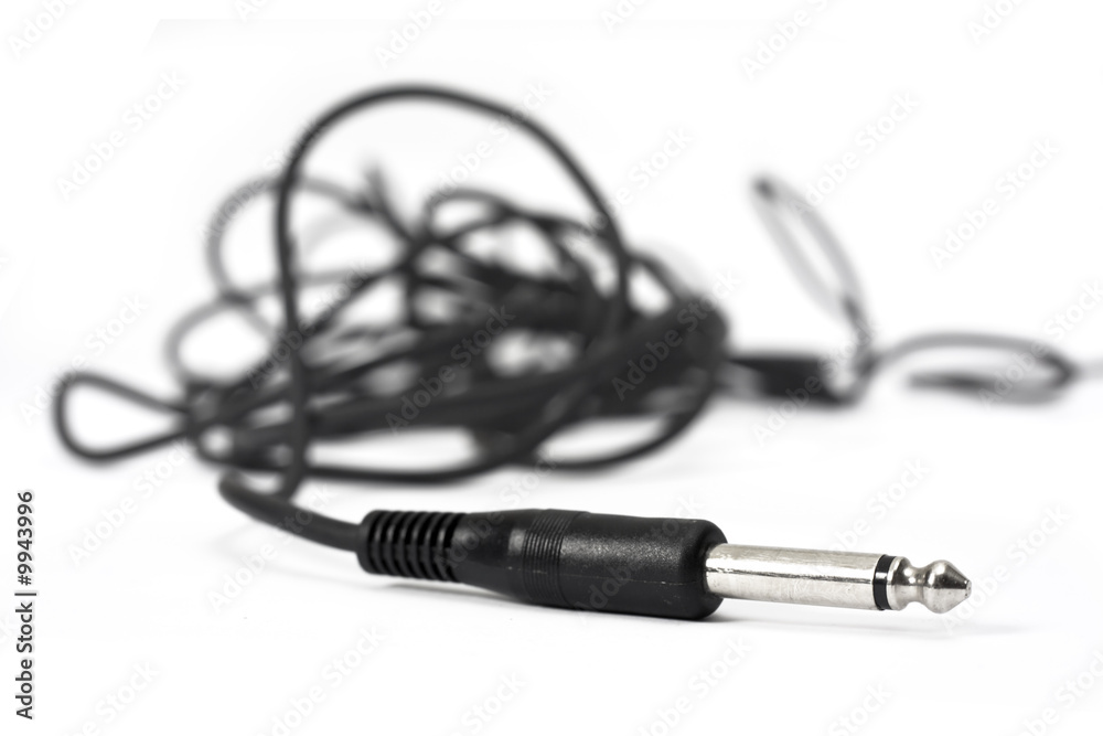 Macro shot of wire with audio headphone connection plug. Macro shot of wire with audio headphone connection plug.