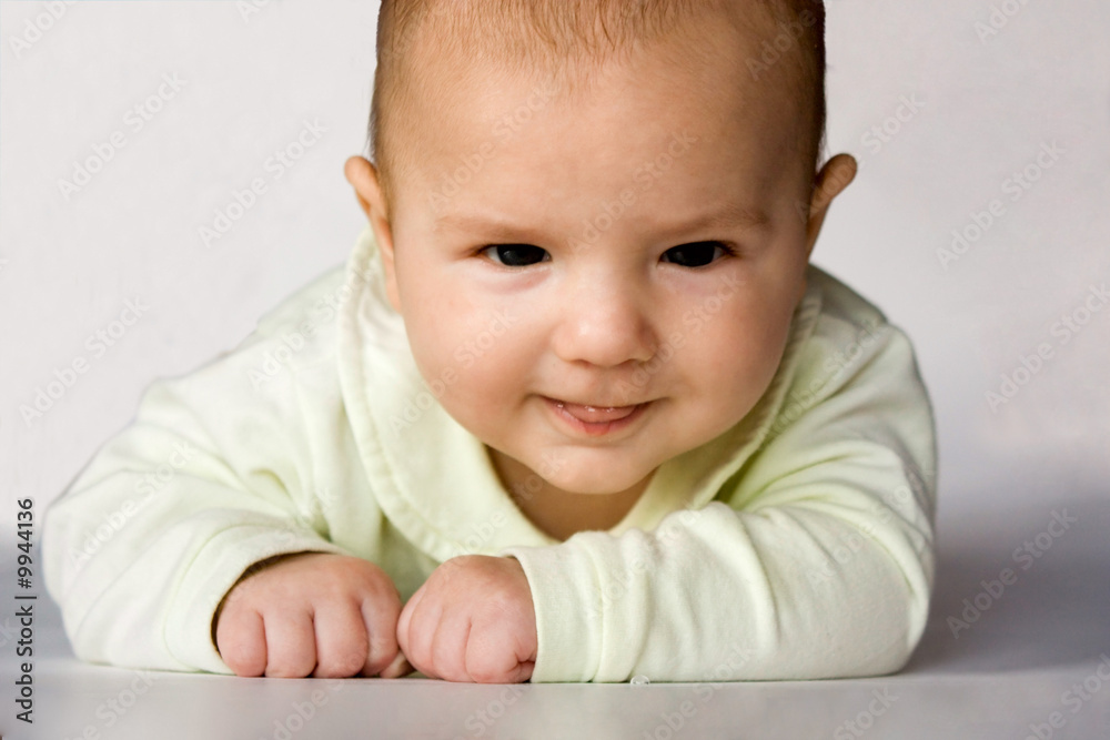 cute baby with sly eyes puting out his tongue cute baby with sly eyes puting out his tongue