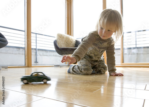 2 and half year old boy playing with a classic car