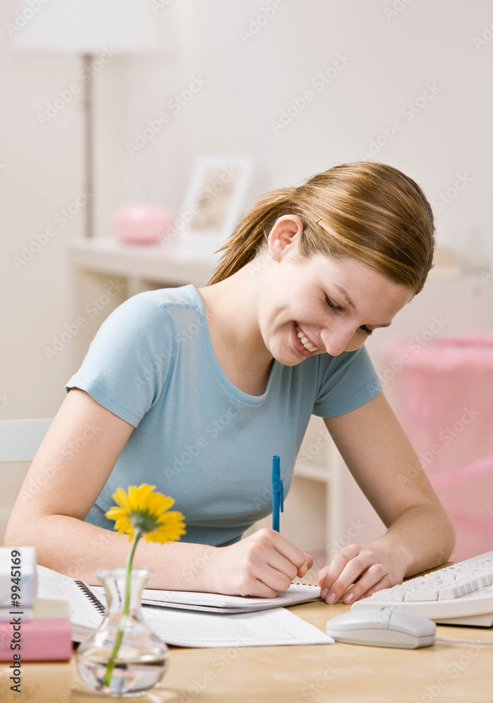Determined girl doing homework in bedroom