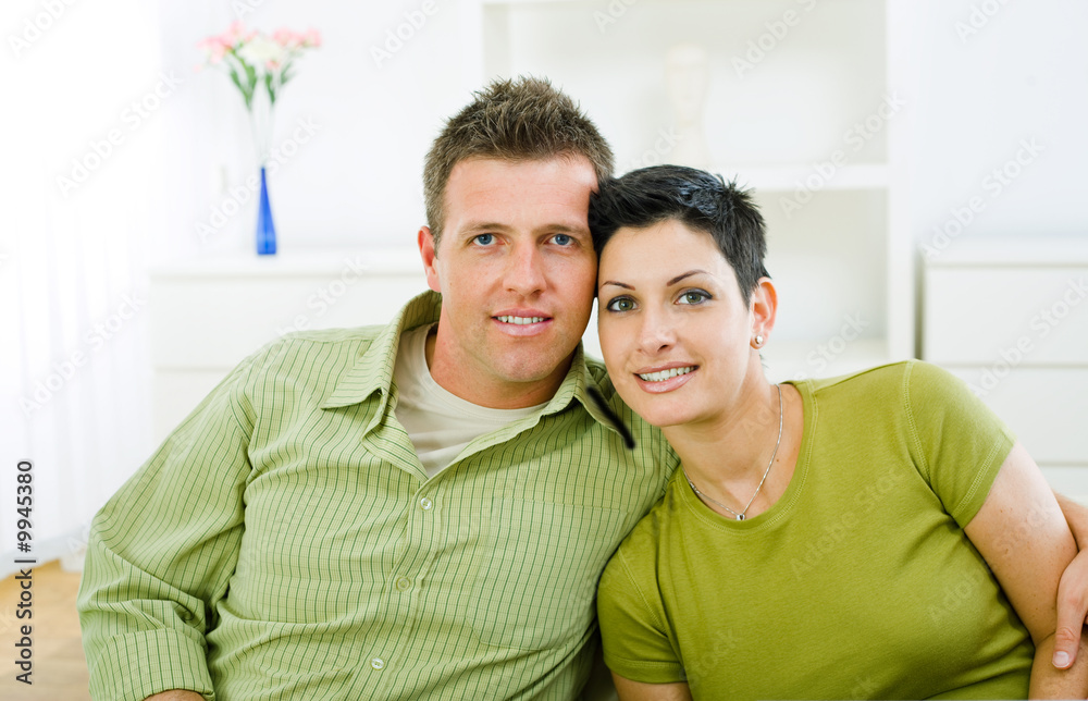 Happy love couple cuddling at home, smiling. Happy love couple cuddling at home, smiling.