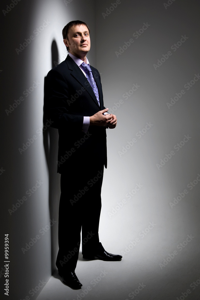 handsome man is standing with a smile handsome man is standing with a smile