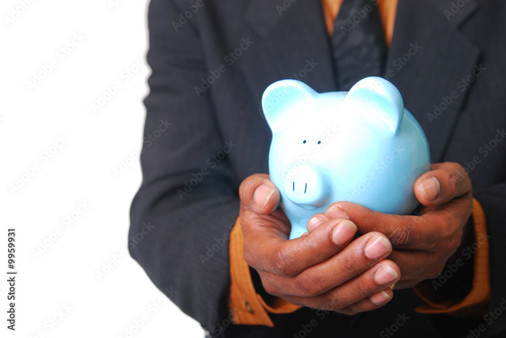 African-American male hands cradling a piggy bank. African-American male hands cradling a piggy bank.