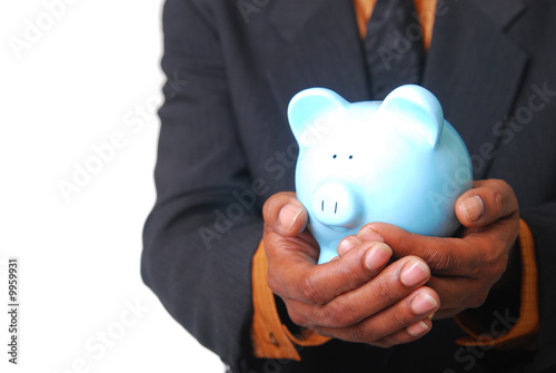 African-American male hands cradling a piggy bank.