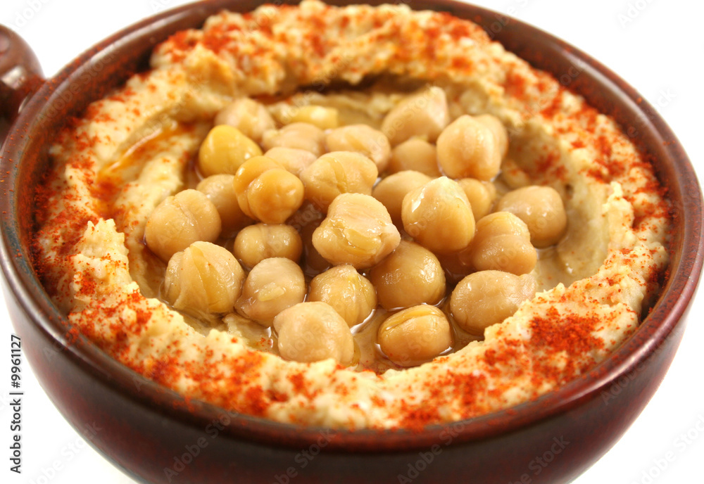Earthenware bowl with delicious hommus and chickpeas Earthenware bowl with delicious hommus and chickpeas