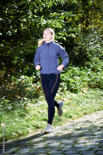 A female runner outdoors in a countryside setting