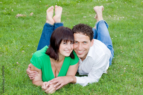 Young, happy and smiling couple in a park.