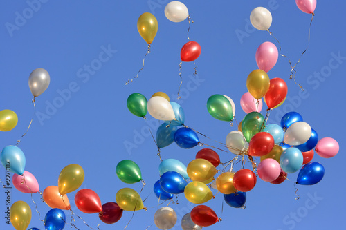 A lot of balloons in the blue sky.