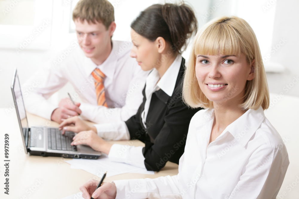 The nice business woman and its partners on a workplace The nice business woman and its partners on a workplace