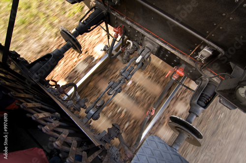 A view between the trains riding on a track. photo