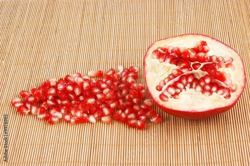 Ripe juicy pomegranate on wooden background