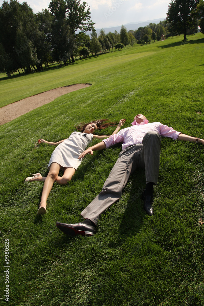 To fall in love, men and woman lying on green grass