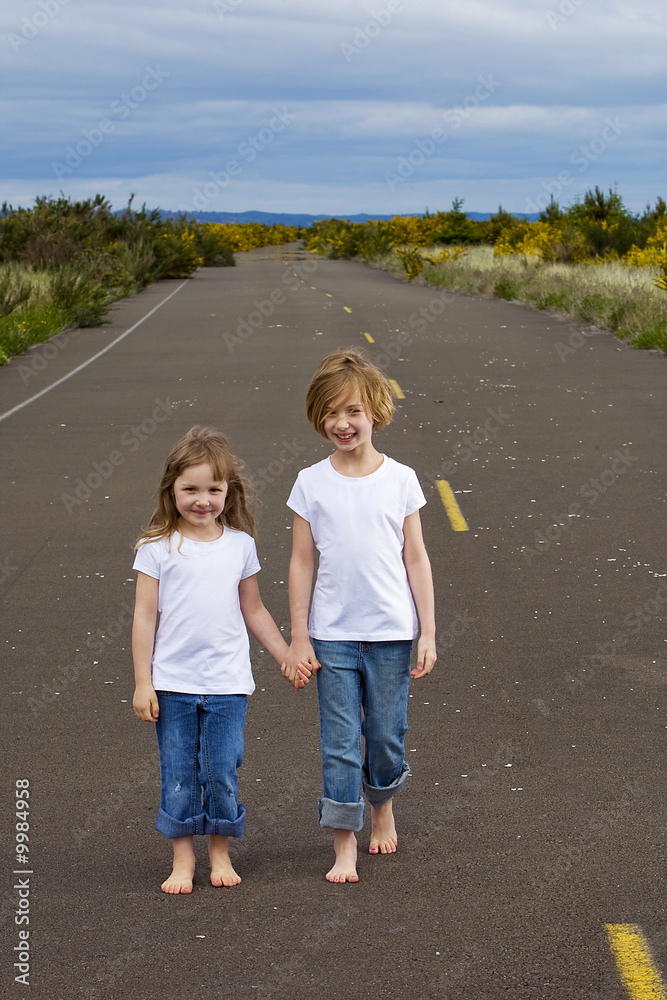 two kids walking down the street two kids walking down the street