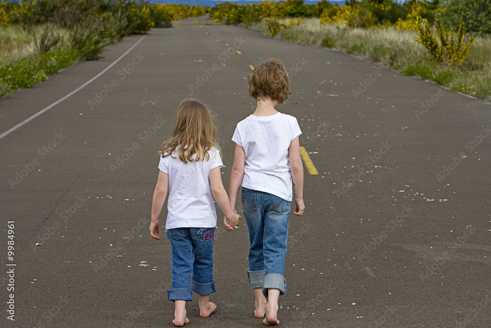 children walking down empty road children walking down empty road