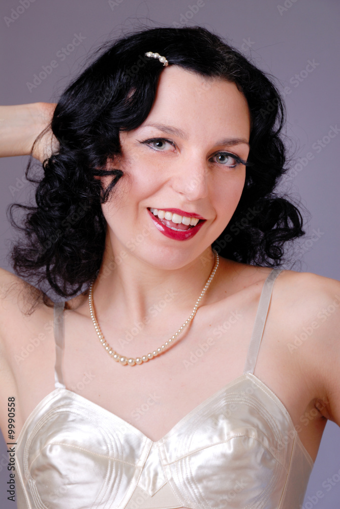 Retro fifties pin-up pretty girl in vintage satin bra & girdle Stock Photo