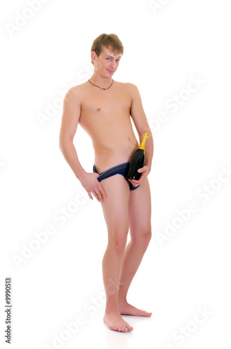 Young handsome gigolo man in briefs, holding champagne