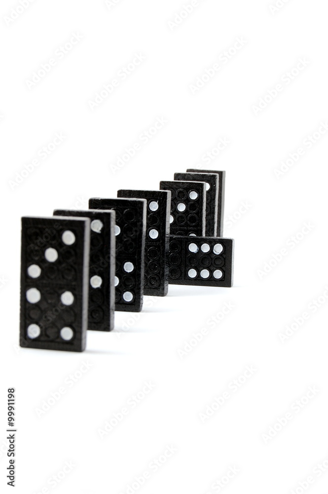 row of dominoes including a special domino stone isolated row of dominoes including a special domino stone isolated
