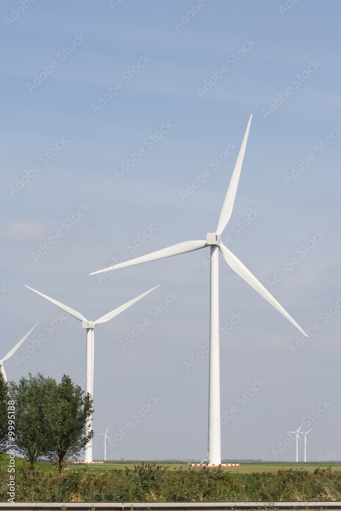 Fototapeta premium White wind turbine standing on open plain.