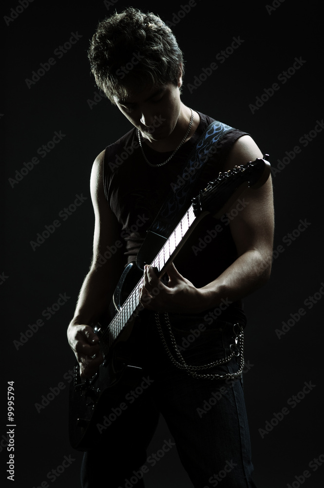 young musician playing in the darkness young musician playing in the darkness