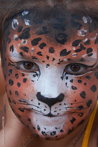 cute girl kid face with painted panther color mask
