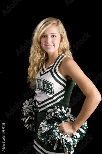 beautiful blond cheerleader with pom pons over black photo
