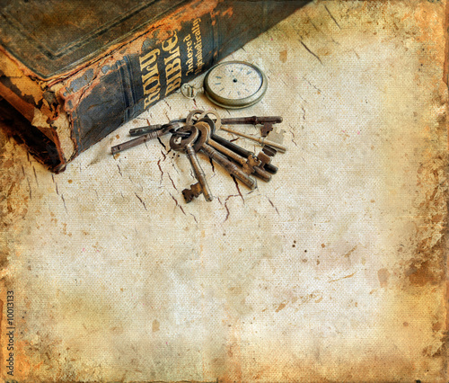 Vintage Bible with pocketwatch and keys grunge background