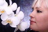 Beautiful young woman and white phalaenopsis orchid
