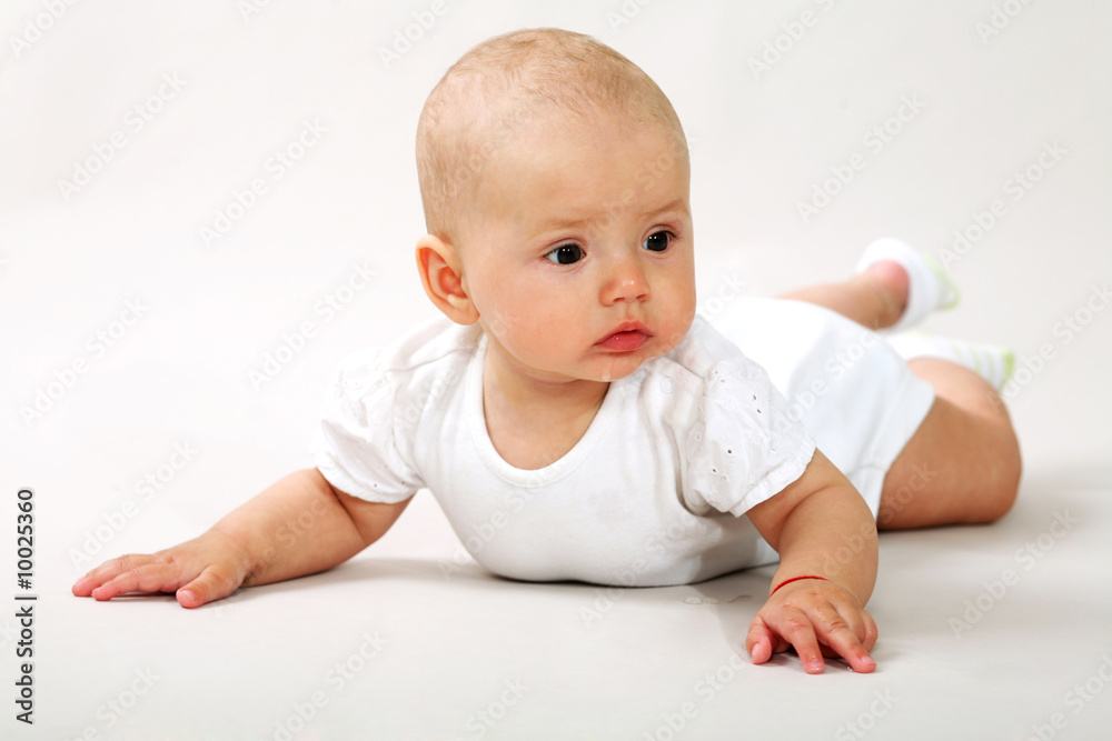 An image of a little baby-girl crawning in studio