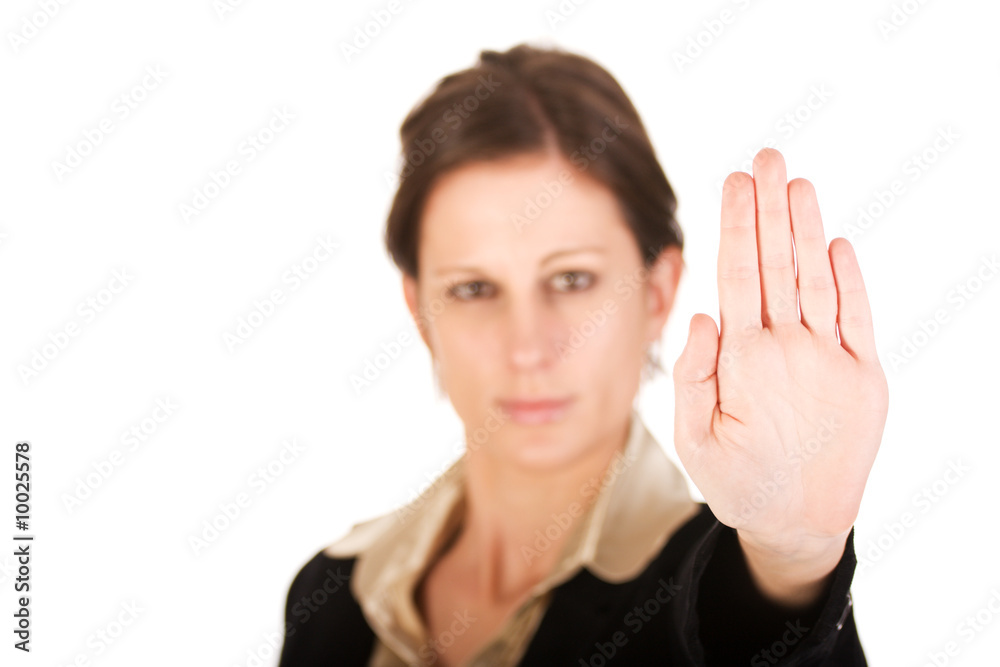 Brunette business woman holding hand up, looking annoyed Brunette business woman holding hand up, looking annoyed