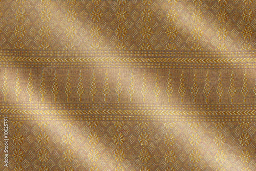 Intricate pattern of a gold Songket cloth