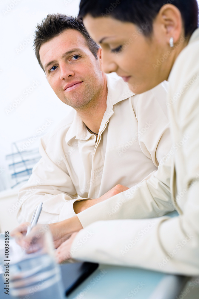 Business couple working at office, smiling. Business couple working at office, smiling.