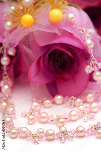 A pink beads necklace put with flower