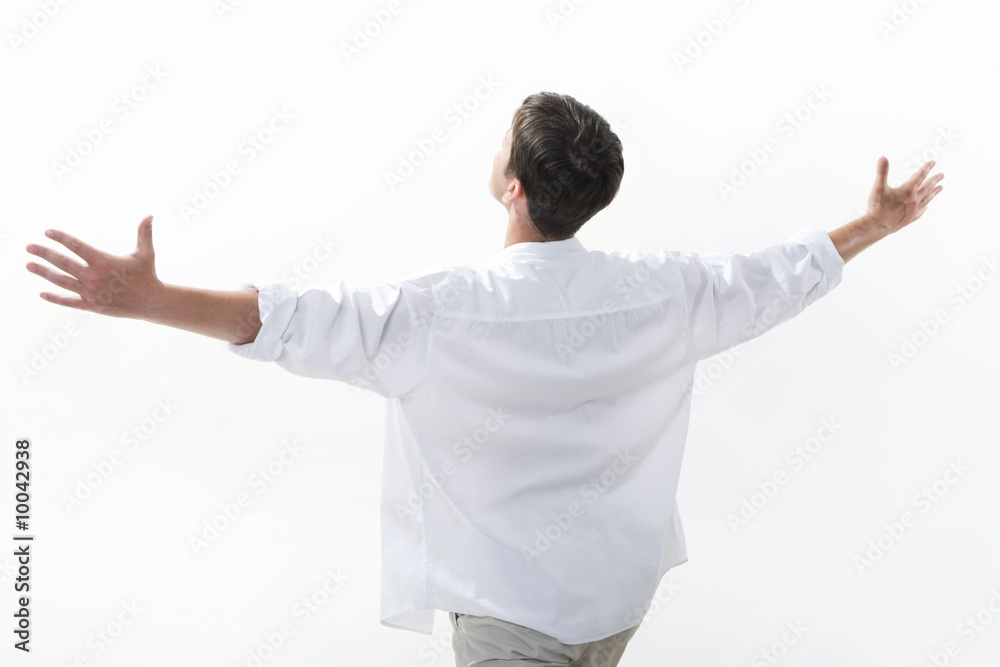 View from aside of happy young man raising his arms