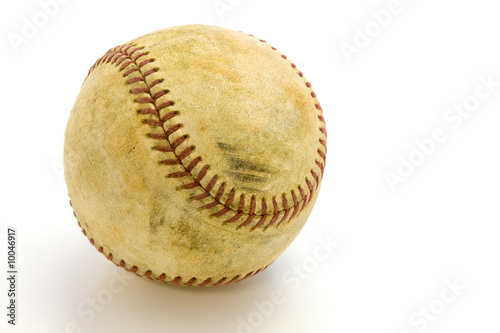 Old, skuffed baseball  on a white field with a clipping path