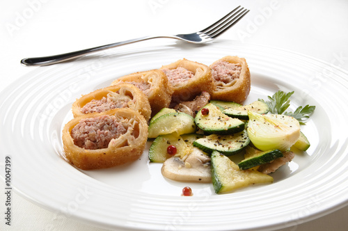 Stuffed fried pancakes with meat and vegetable salad
