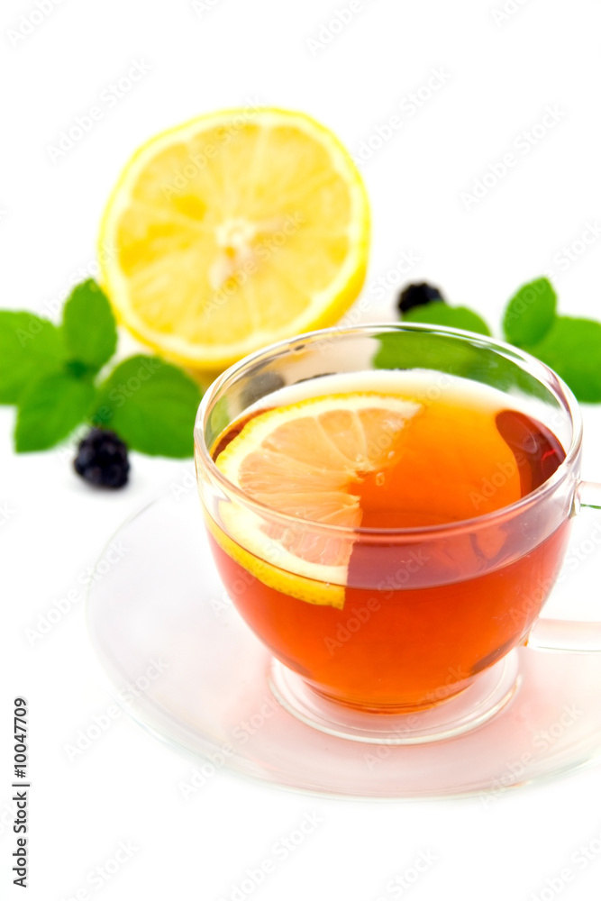 Transparent teacup with tea and lemon Transparent teacup with tea and lemon