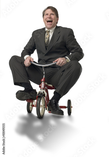 Executive riding child's tricycle