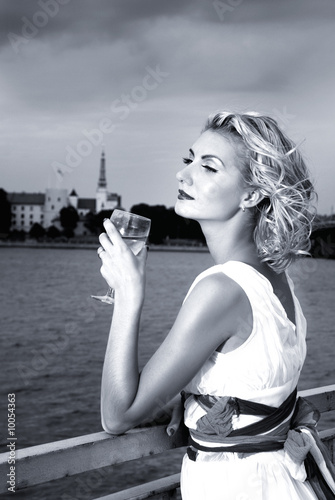 Beautiful blond girl drinks champagne