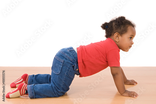 Adorable african baby crawl over wooden floor