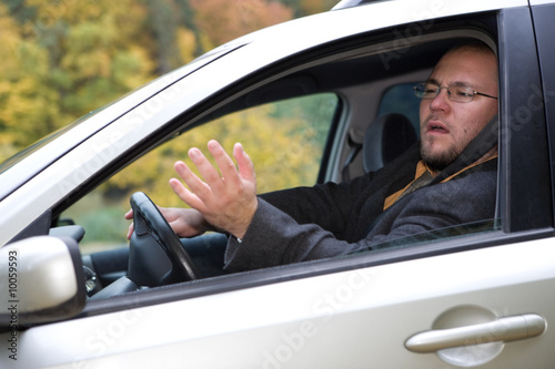 angry man driving by car