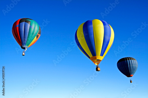 Colorful hot air balloons against a clear blue sky